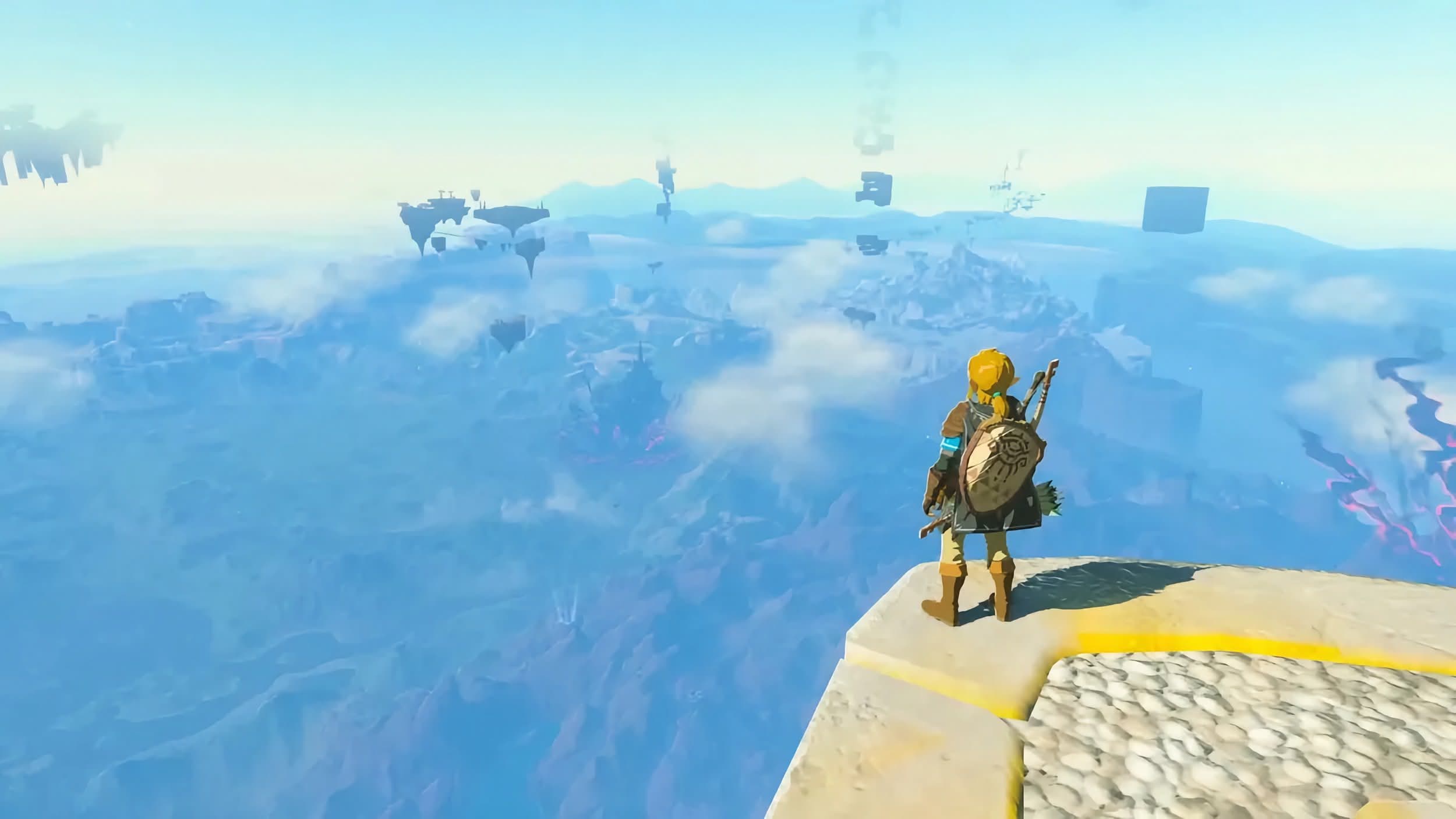 Screenshot from The Legend of Zelda: Tears of the Kingdom showing Link standing on a floating island looking out over the world below.